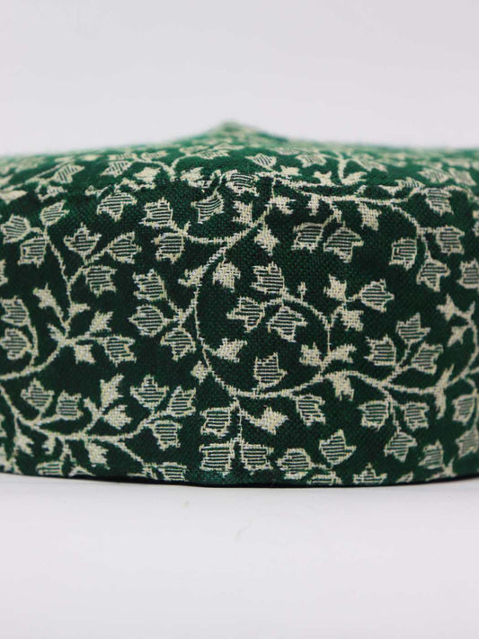 green cap from Kashmir in kani woven pattern