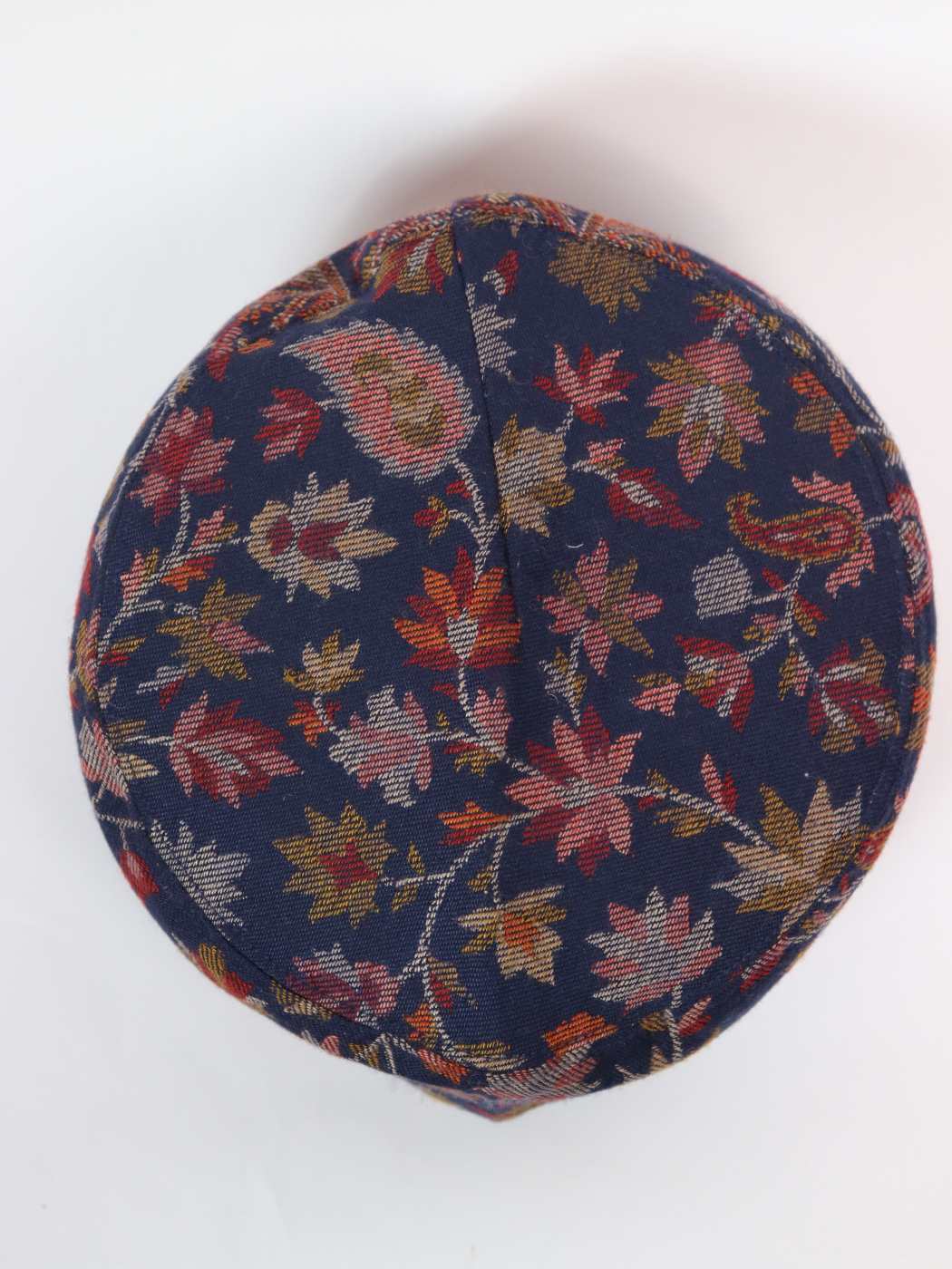 round cap in dark blue with floral patterns