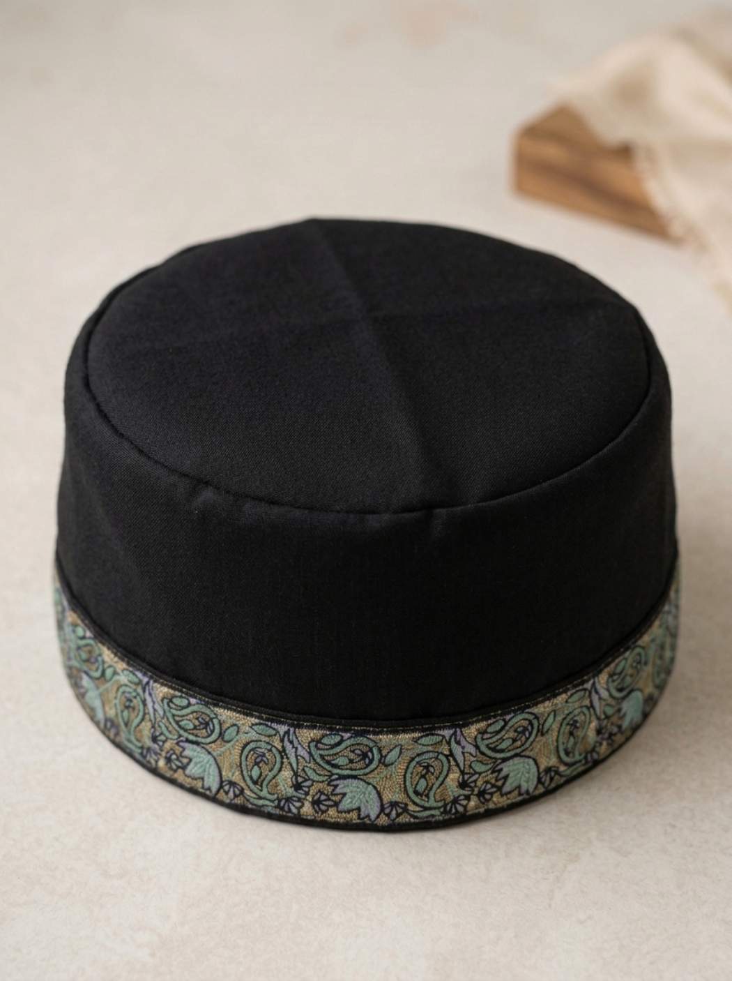 black Kashmiri cap with sozni embroidery across border
