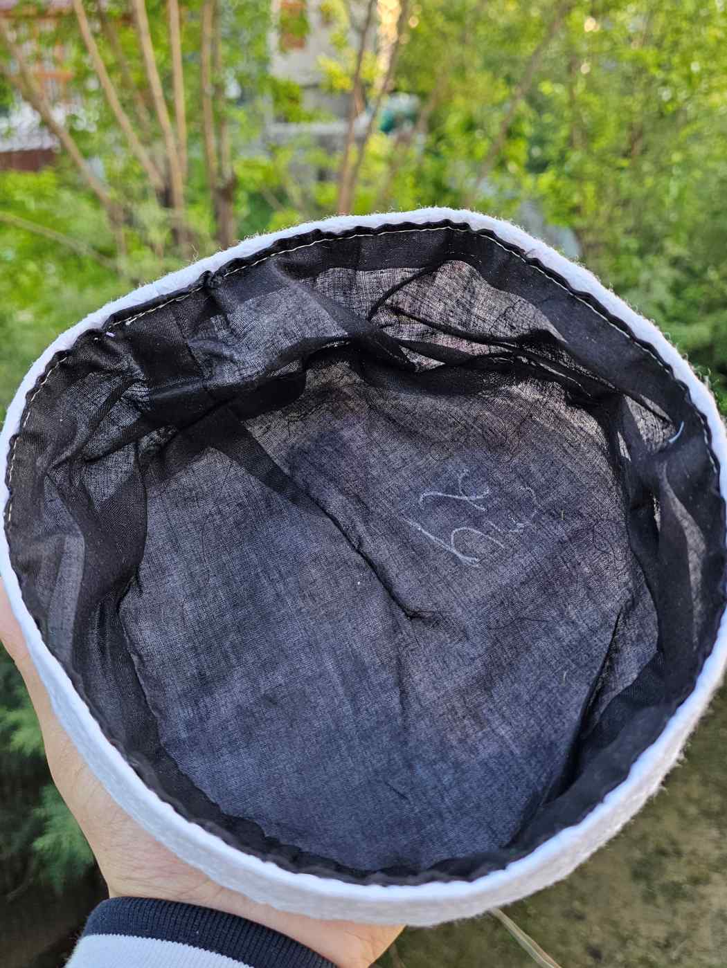 Black lining inside a white cotton cap