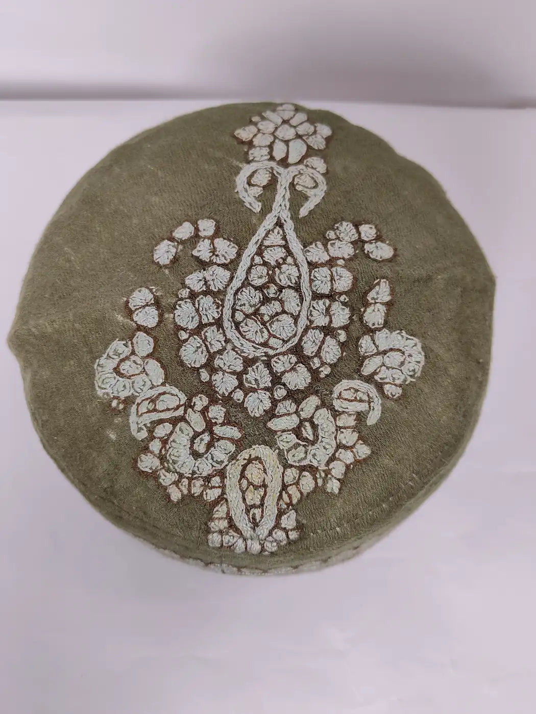 green cap with hand sozni embroidery on top side