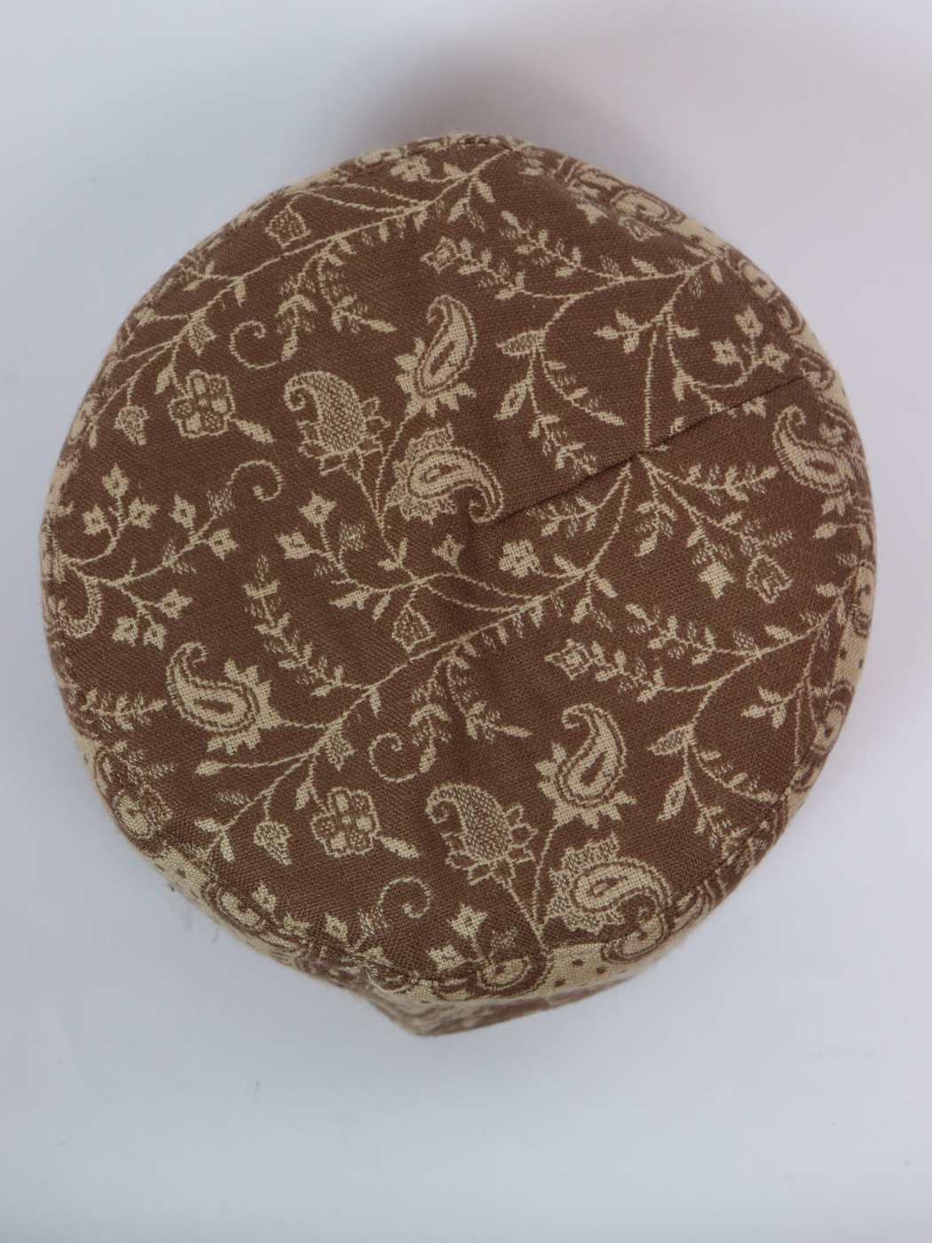 round brown cap in floral woven pattern