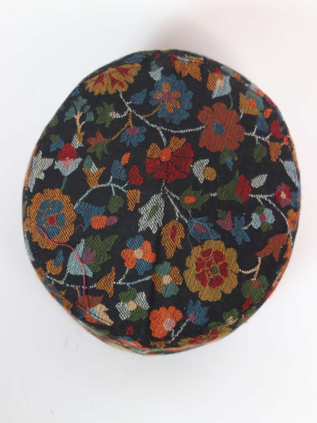 black cap top side in woven floral motifs