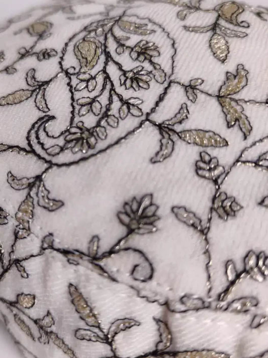 paisley motif in zari work on the white cap