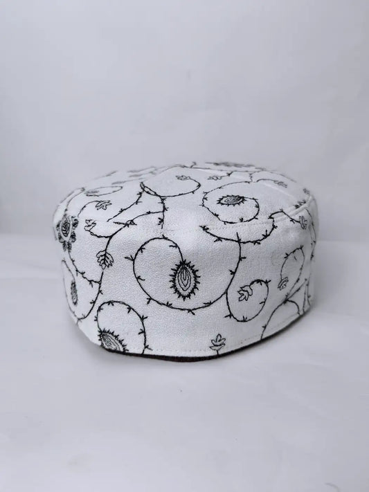 white cap with needlework
