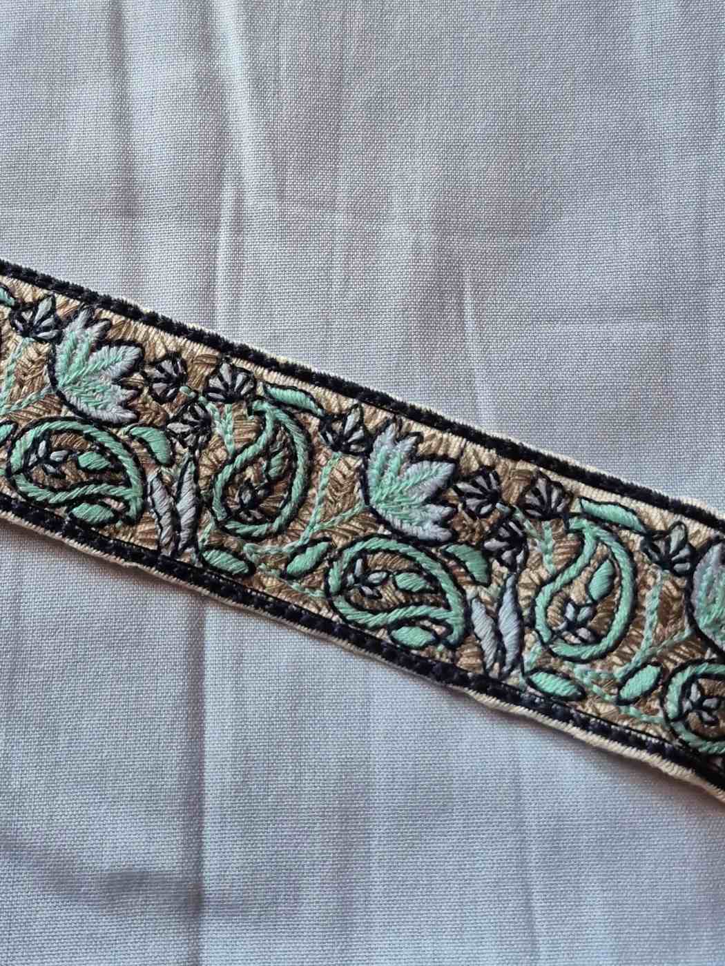 Embroidered paisley sozni pattern on a fabric patch 