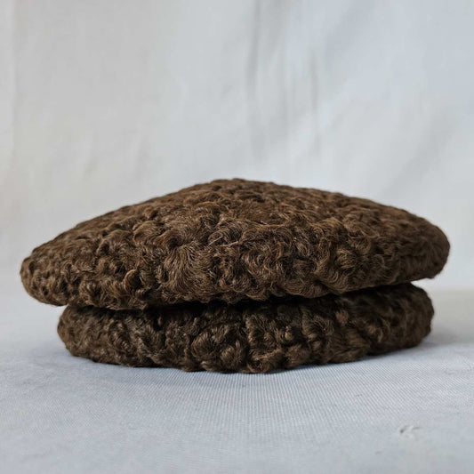 dark brown cap in karakul fur