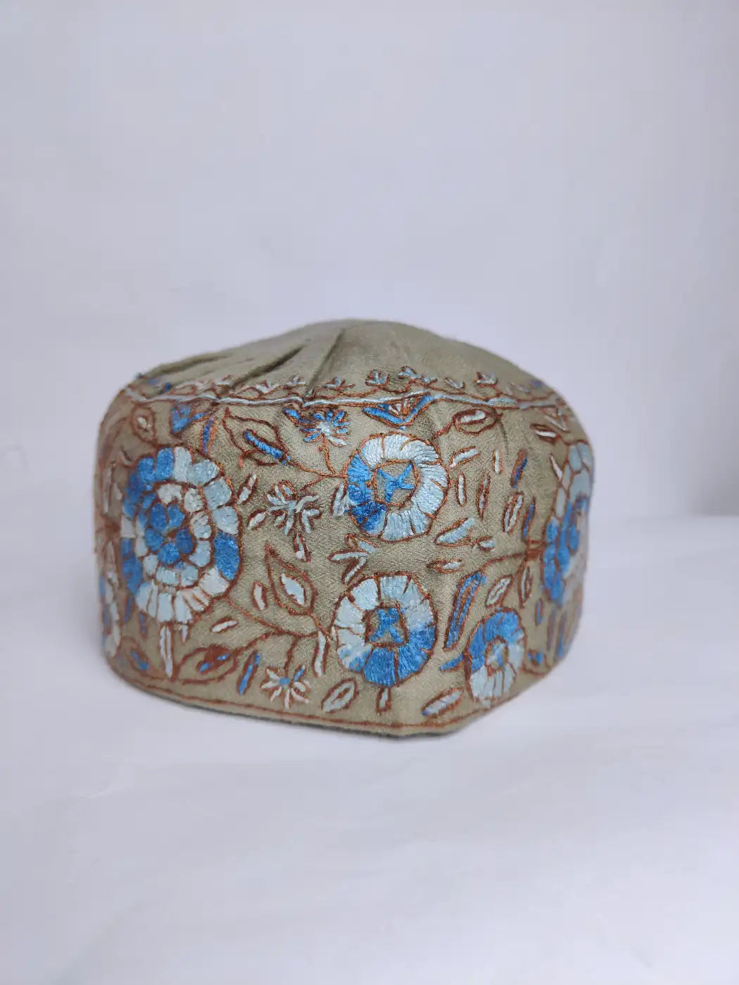 floral paper machie hand sozni embroidery across sides of the round Kashmiri cap