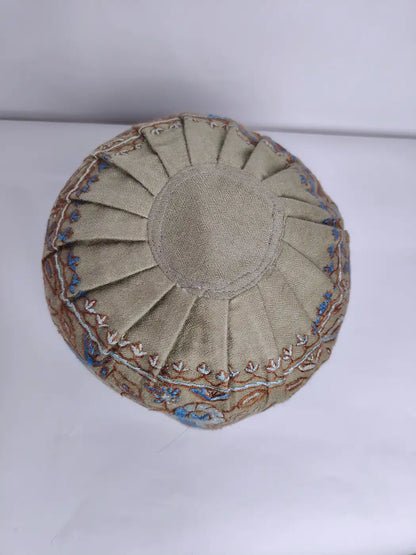 top side of the beige hue kashmiri mens cap neatly folded