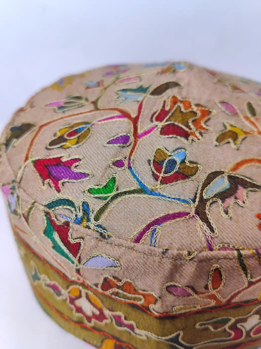 kalamkari work on the beige colour kashmiri cap
