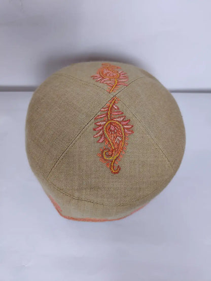 top side of the beige Kashmiri round cap in hand sozni paisley design 