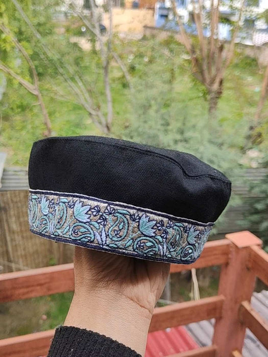 Black cap with paisley pattern in sozni embroidery across border