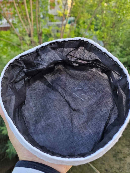 Black lining inside a white cotton cap 