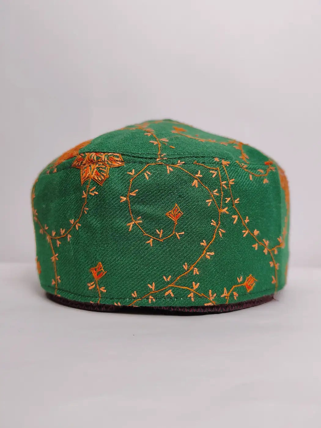 Green embroidered cap on a white background
