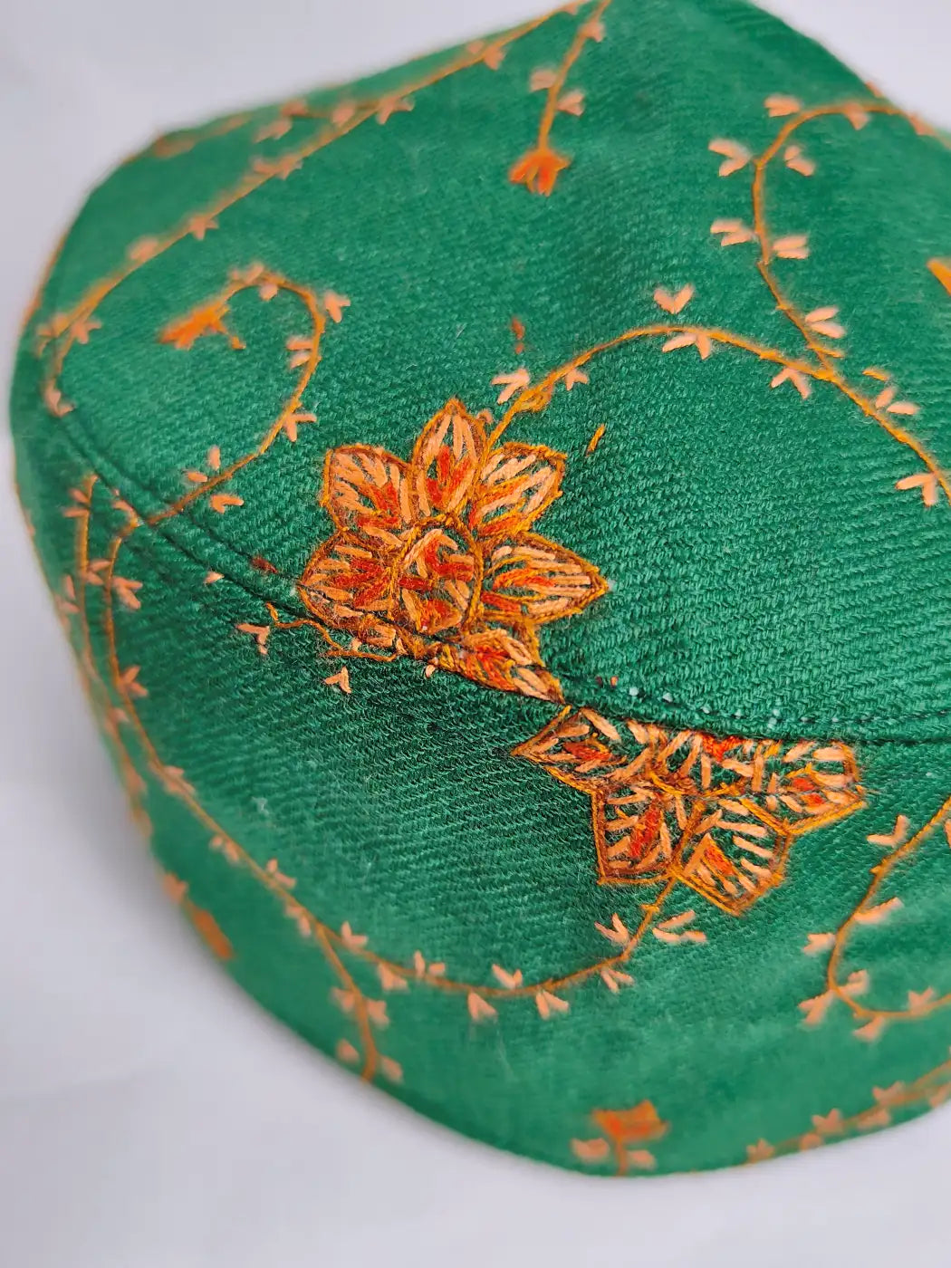 Green cap with orange floral embroidery