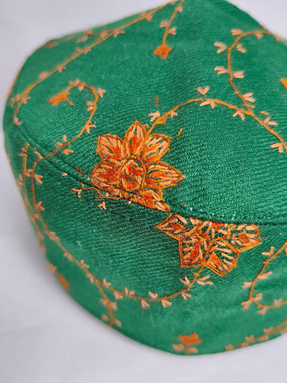 Green cap with orange floral embroidery