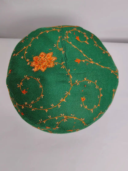 green cap with sozni embroidery