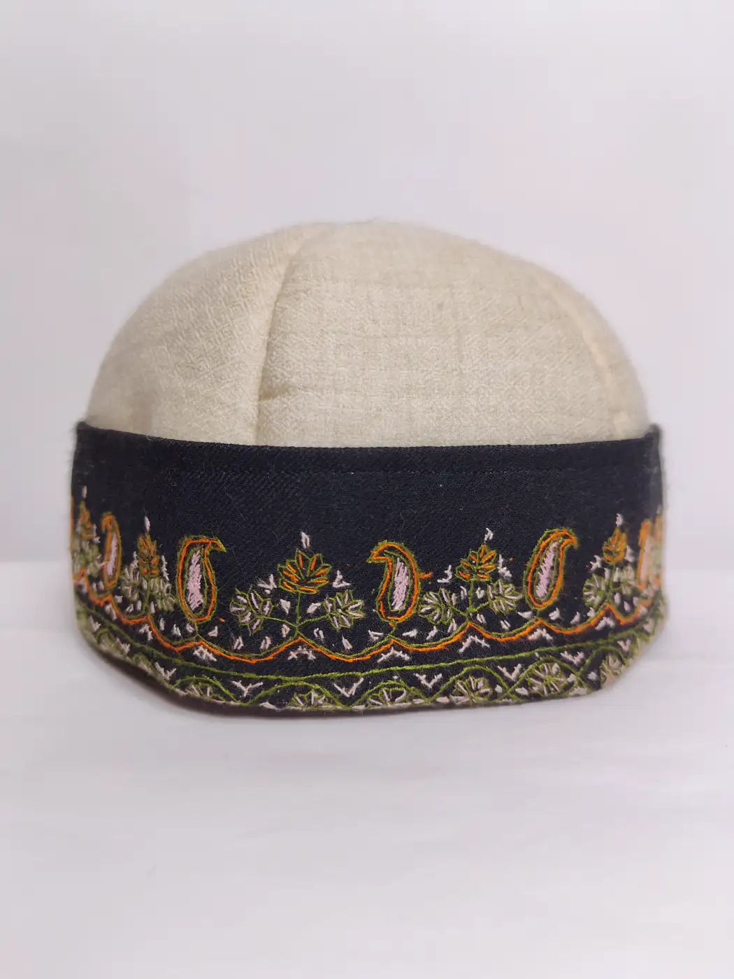 kashmiri cream cap with sozni embroidery across the border in continuous badam pattern 