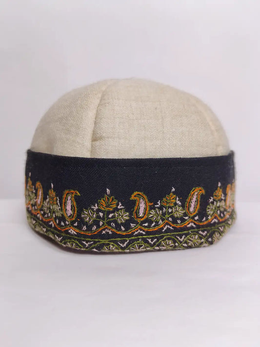 kashmiri cream cap with sozni embroidery across the border in continuous badam pattern 