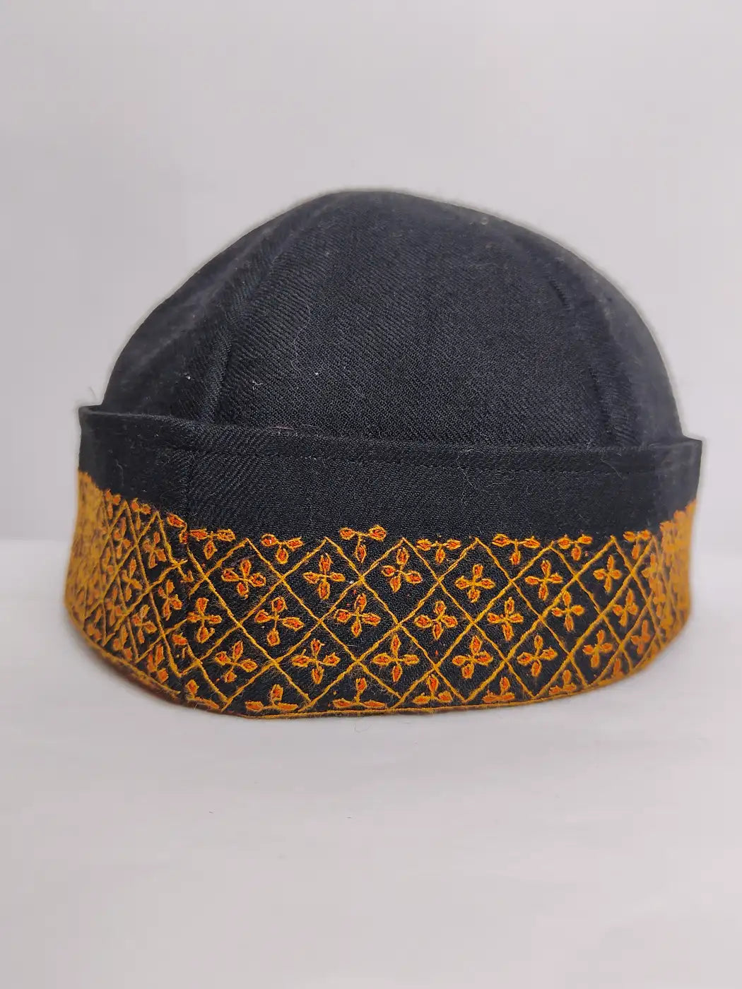 Kashmiri cap in black with geometrical sozni embroidery across border 