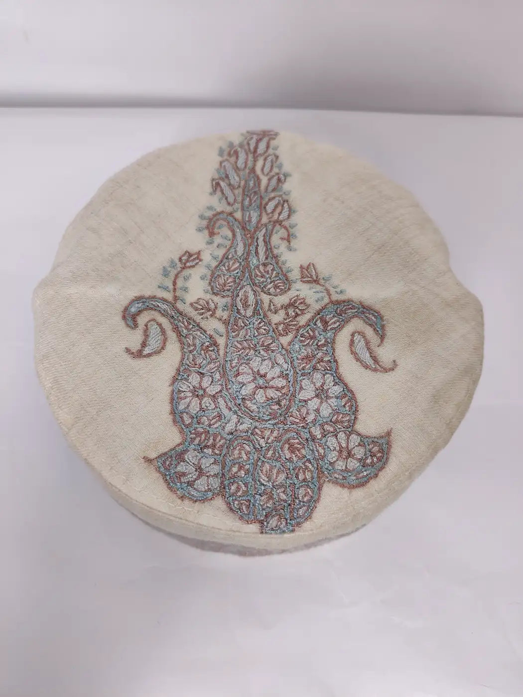 round cap from Kashmir with and sozni on top side in paisley motif 