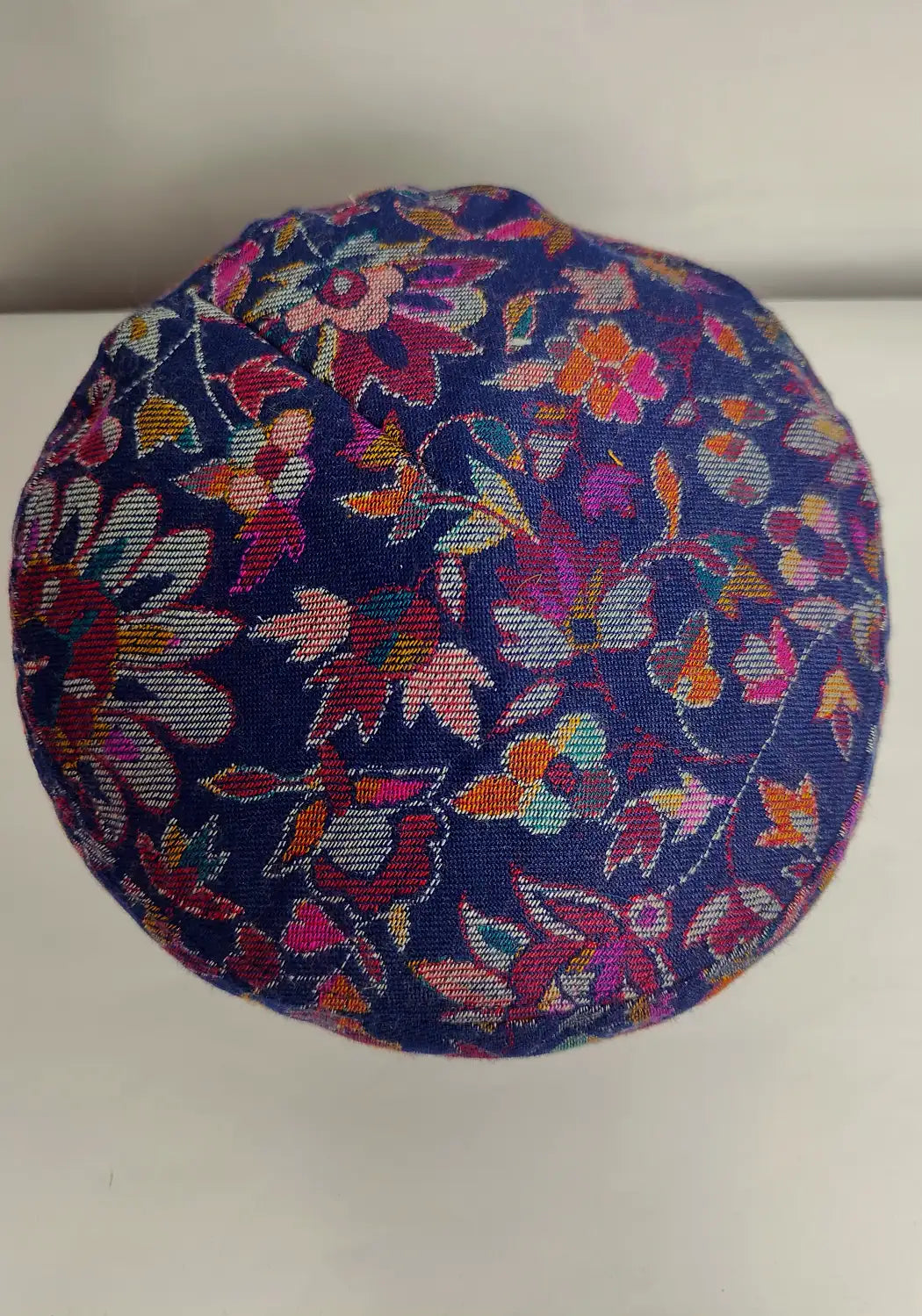 dark blue kani cap top side in floral woven pattern