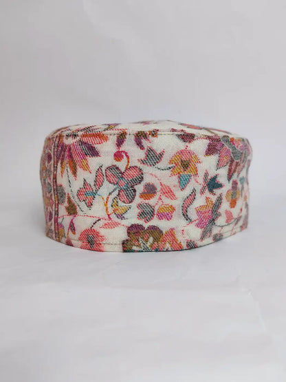 white kani cap with florals across sides