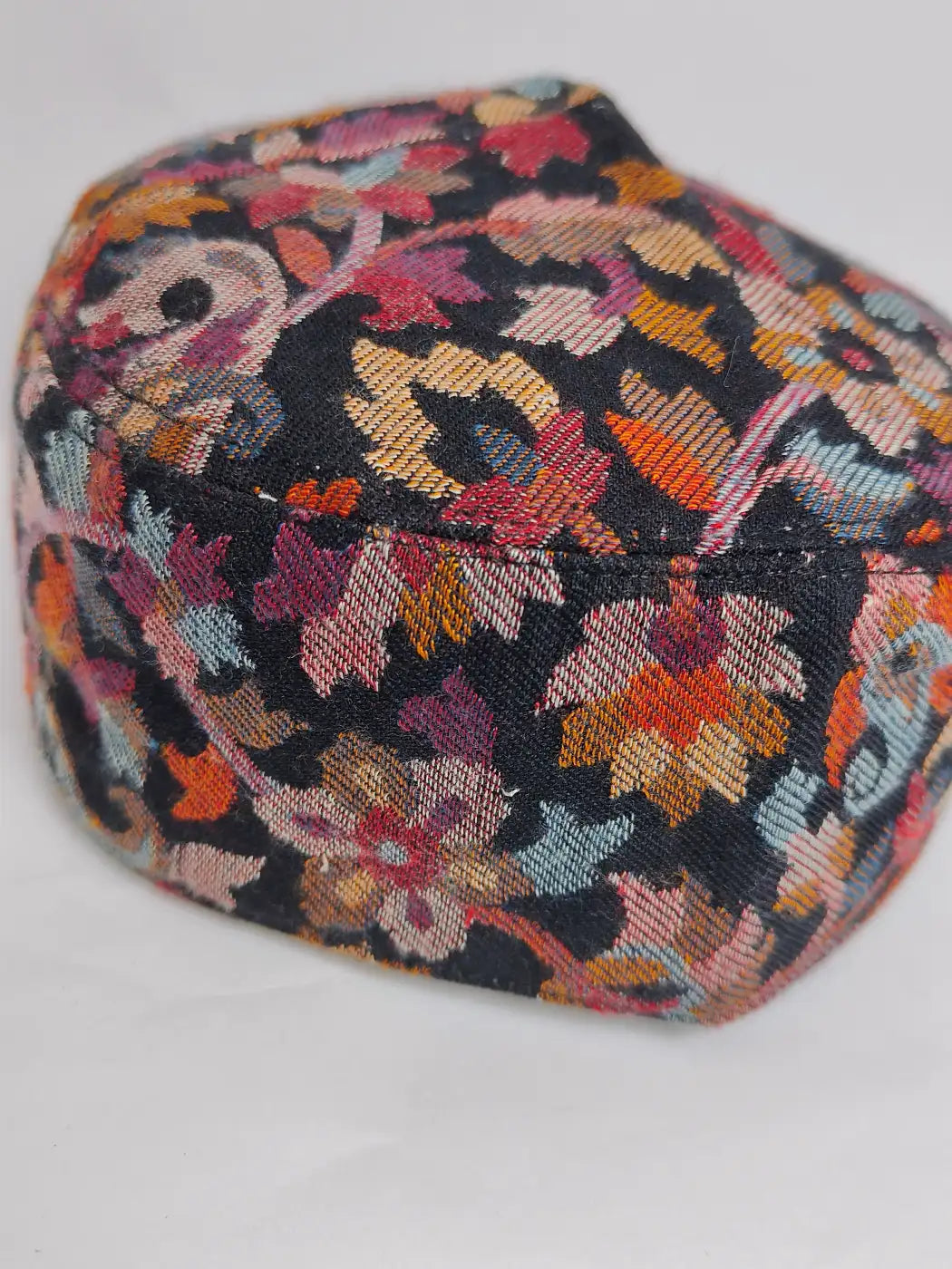 floral black cap in kani woven motifs 