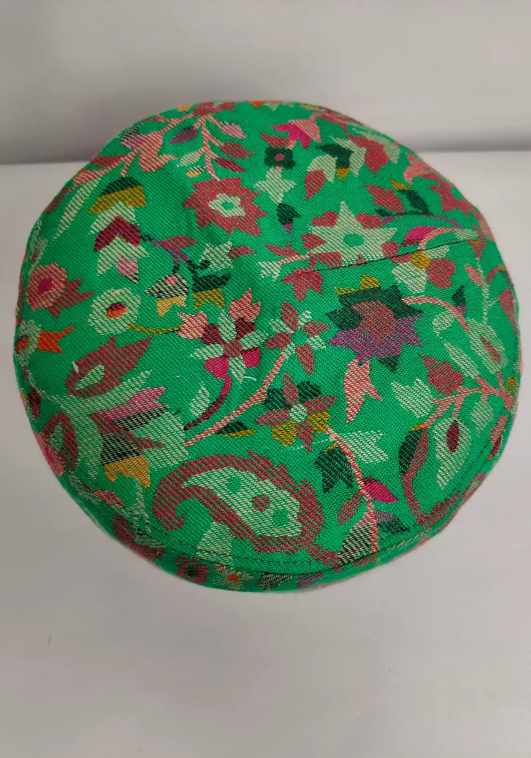 top side of kani cap in floral work on top side 