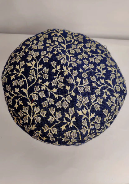 floral detailing on the top side of the dark blue traditional kani cap