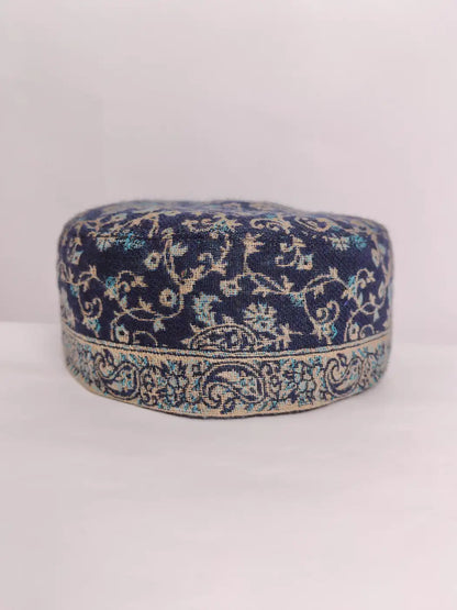 dark blue cap with badam vine pattern across border