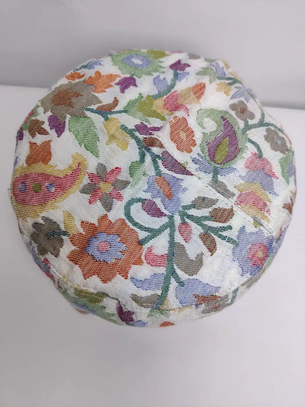 white kani cap in florals on top side