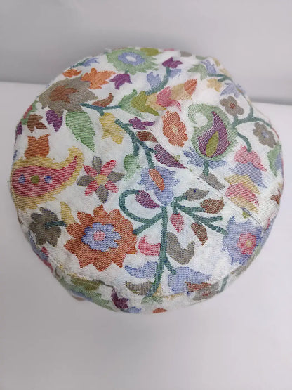 white kani cap in florals on top side
