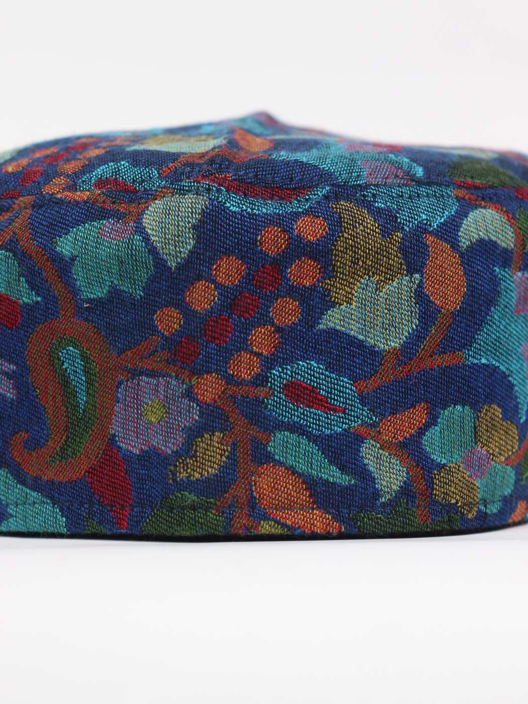green cap in woven florals