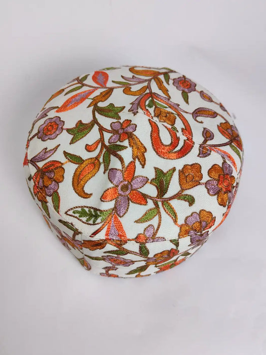 white foldable cap with nalki aari embroidery on top side