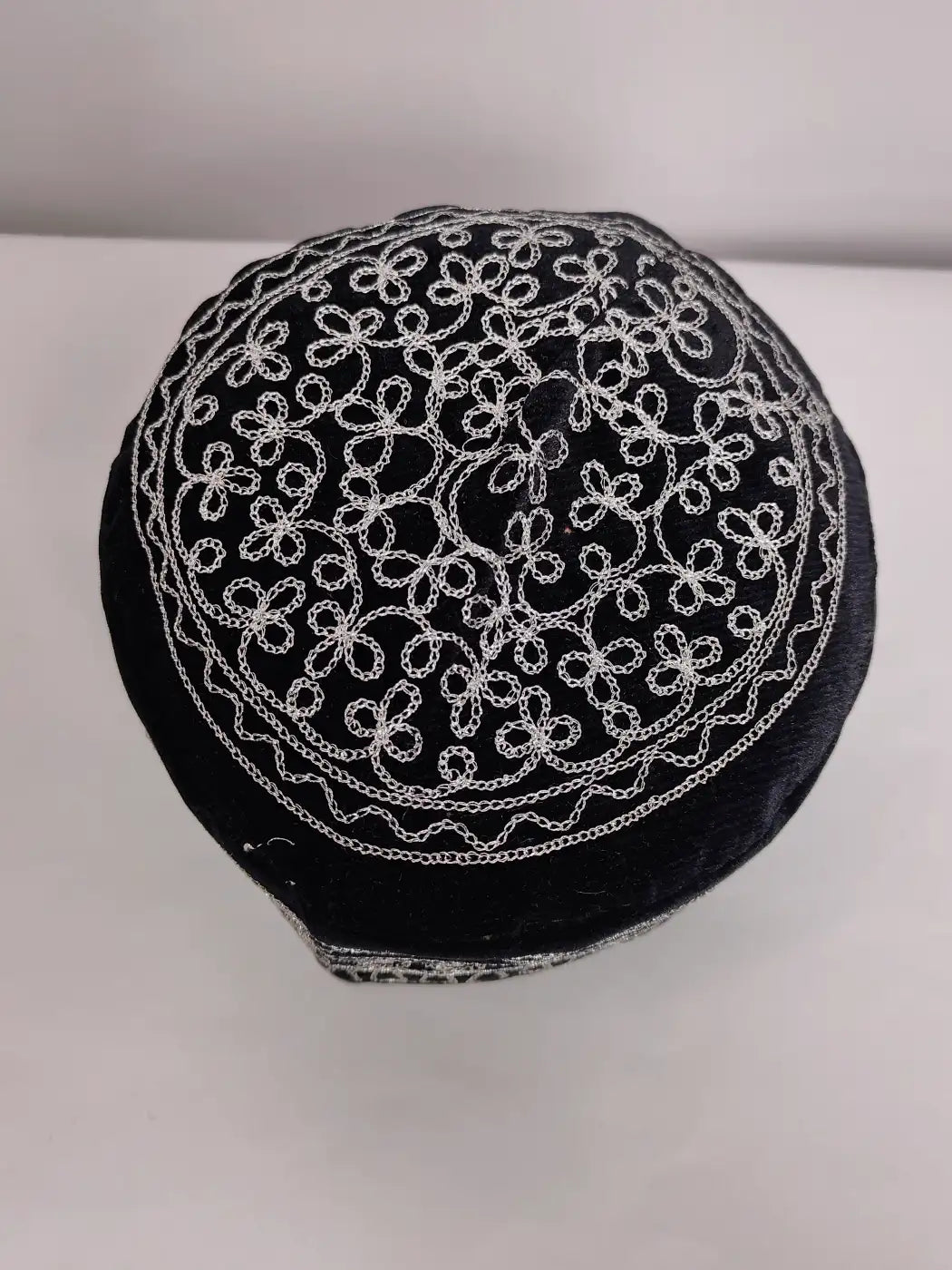 Black cap with silver intricate patterns in zari till work