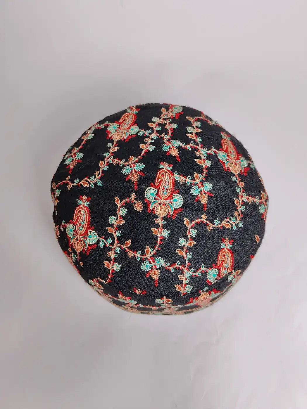 black round cap with sozni work on top side 