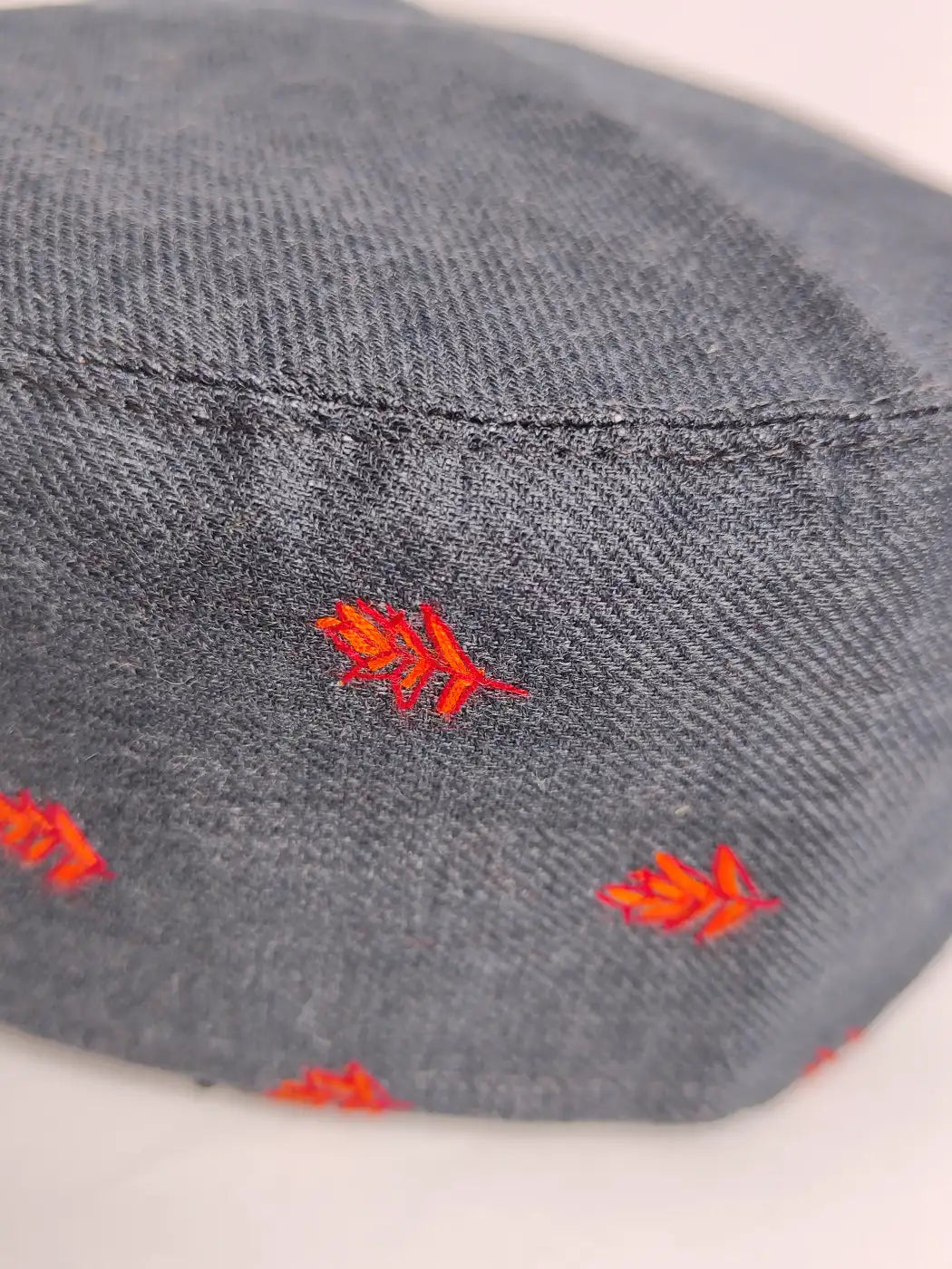 Kashmiri cap sozni embroidery against black