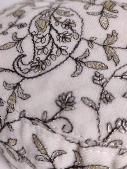 paisley motif in zari work on the white cap