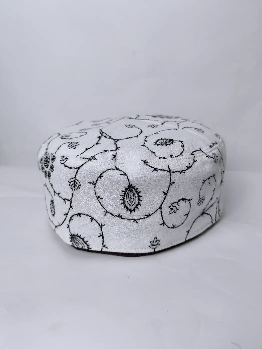 white cap with needlework