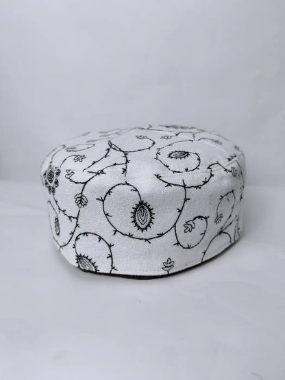 white cap with needlework